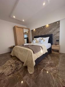 a bedroom with a large bed and a large mirror at Villa Ana in Kastel Sucurac