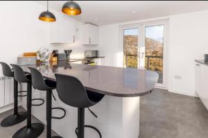 a kitchen with a large marble table and chairs at Taigh John in Cluer +4 photos