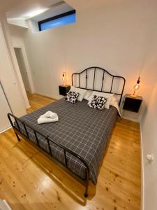 a bedroom with a large bed with two lamps on it at Stay Well Home in Lisbon
