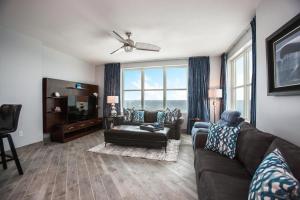 a living room with a couch and a chair at Aqua 801 in Panama City Beach