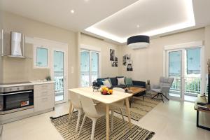a kitchen and living room with a table and chairs at Luxury Apartment next to Athens - Greecing in Athens