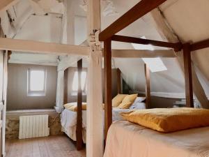 a bedroom with two bunk beds in a room at La maison sur les remparts in Domfront