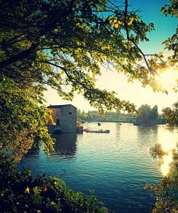 a house on a lake with the sun setting at Mirador de las cigüeñas in Zamora