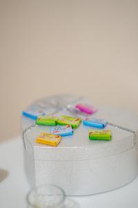 a white cake with four colorful toothbrushes on it at Big Lale UR in Bijeljina