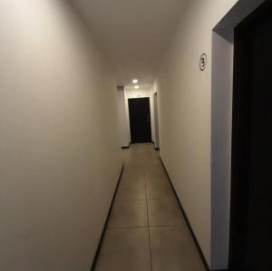 an empty hallway with a black door and a room with white walls at Home Alojamientos Temporales in San Luis
