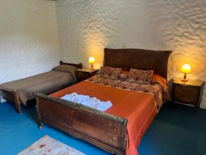 1 dormitorio con 2 camas y 2 lámparas en 2 mesas en "La Loma" - Vieja Casona en El Calafate