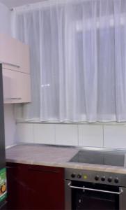 a kitchen with a counter top and a window at Ylli Shabani in Tirana