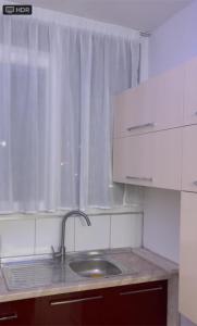 a kitchen with a sink and a window at Ylli Shabani in Tirana