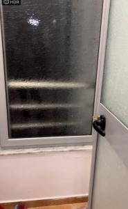 drzwi z oknem z mokrym szkłem w obiekcie Ylli Shabani w Tiranie