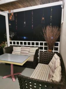 um pátio com uma mesa e cadeiras, uma mesa e uma janela em Boho Sisi Resort em Sissi