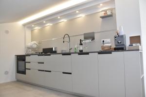 a kitchen with white cabinets and a counter top at I Secolari di Giulia in Avola