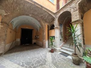 een hal van een gebouw met twee potplanten bij Domus Isidis room in Benevento
