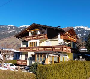 a large house with wooden accents on it at Haus Holzer in Dorfgastein