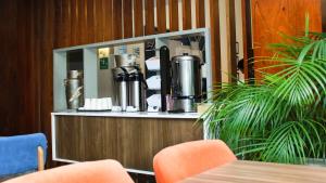 a restaurant with a counter with a coffee machine at Holiday Inn Express Culiacan by IHG in Culiacán +115 photos