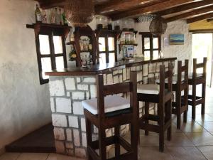 a bar in a room with a bunch of chairs at Manga Lodge in Andavadoaka