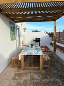 a picnic table under awning on a patio at apartamento nº 7 cala pregonda in Cala Blanca