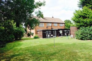 a house with a lawn in front of it at Charde Guest House in Birmingham