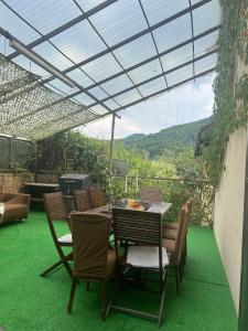 a patio with a table and chairs with a view at Luxury Apartment Oasis in Timisul de Jos