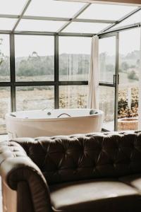 a living room with a bath tub and a couch at Cabana Estufa in Mafra +20 photos