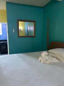 a bedroom with a bed with a mirror on the wall at Bay Heights Escape in Gros Islet