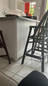 a chair sitting next to a counter in a kitchen at Bay Heights Escape in Gros Islet