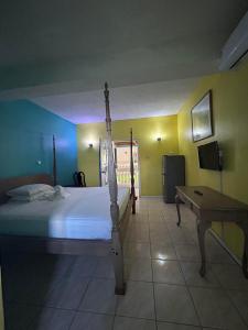 a bedroom with a bed and a desk in it at Bay Heights Escape in Gros Islet