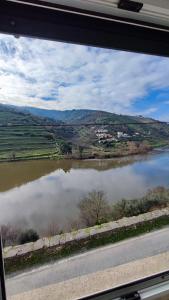 a view of a lake from a train window at The River House in Peso da Régua