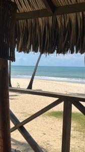 a view of the beach from a thatch roof at Eco Paradise 110 - Cumbuco in Caucaia