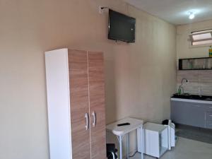 a small kitchen with a cabinet and a sink at kitnets Luz Beira mar in Tramandaí +28 photos