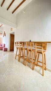 a kitchen with a wooden table and chairs at Hostal la guadalupana in Necoclí