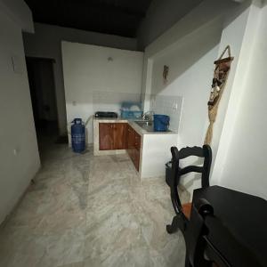an empty kitchen with a sink and a counter at Hostal la guadalupana in Necoclí