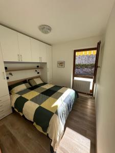 a bedroom with a bed and a window in it at Casa Vacanza La Croseta in Trento