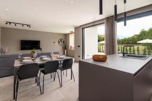 uma cozinha e sala de estar com mesa e cadeiras em Villa Costa em Funtana