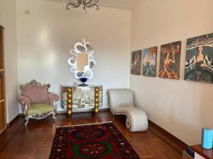 a living room with two chairs and a rug at VILLA TARA in Quercianella