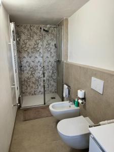 a bathroom with a shower and a toilet and a sink at VILLA TARA in Quercianella