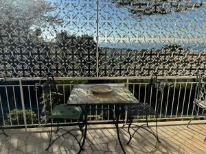 a table and a chair in front of a wall at VILLA TARA in Quercianella