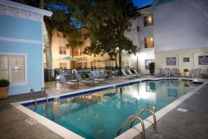 a swimming pool with lounge chairs and a hotel at Residence Inn By Marriott Charleston Mt. Pleasant in Charleston