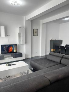 a living room with a couch and a tv at Dream house in Knightswood