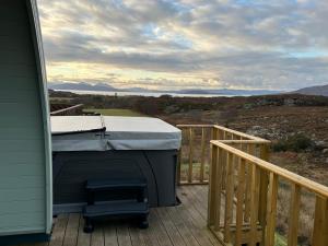a grill on the deck of a house at Duirinish Pods with Private Hot Tubs and Duirinish Bothy with No Hot Tub in Plockton