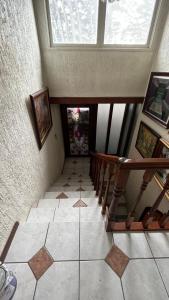 a room with a staircase and a tile floor at Anoka House in Punta Arenas