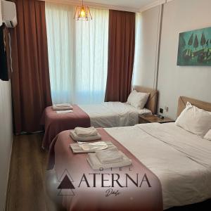 Postel nebo postele na pokoji v ubytování ATERNA HOTEL