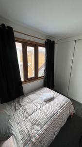 a bedroom with a bed and a window at Anoka House in Punta Arenas