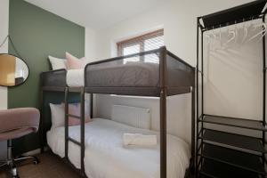 a bedroom with two bunk beds and a desk at Tapton View - Modern Stay Near Chesterfield Town Center, Train Station & the Peak District in Brimington