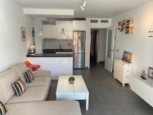 salon z kanapą i stołem w obiekcie Apartamento Nogamar en Fuengirola, a 50 metros de la playa w mieście Fuengirola