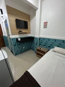 A bed or beds in a room at Mais Hotel Express