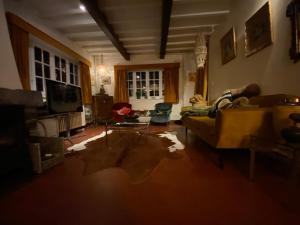 a living room with a couch and a tv at Les Barolins in Rotselaar