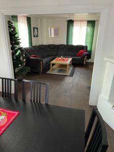 a living room with a black table and a christmas tree at Vacker villa i Fröseke in Fröseke