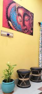 two vases on a table with a painting on the wall at Feel the Bong vibes in a villa nearest to airport. in Kolkata