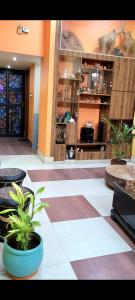 a lobby with plants in pots on the floor at Feel the Bong vibes in a villa nearest to airport. in Kolkata