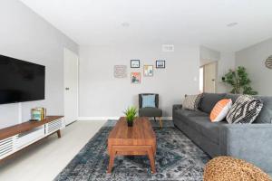 a living room with a gray couch and a coffee table at 5 Mins to DT Alhambra - Homey 2BR Apt 4A in Alhambra